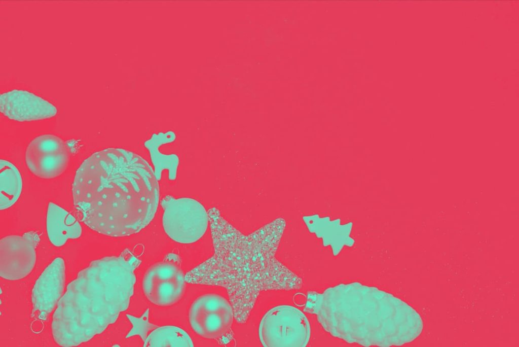 green Christmas baubles on a red background