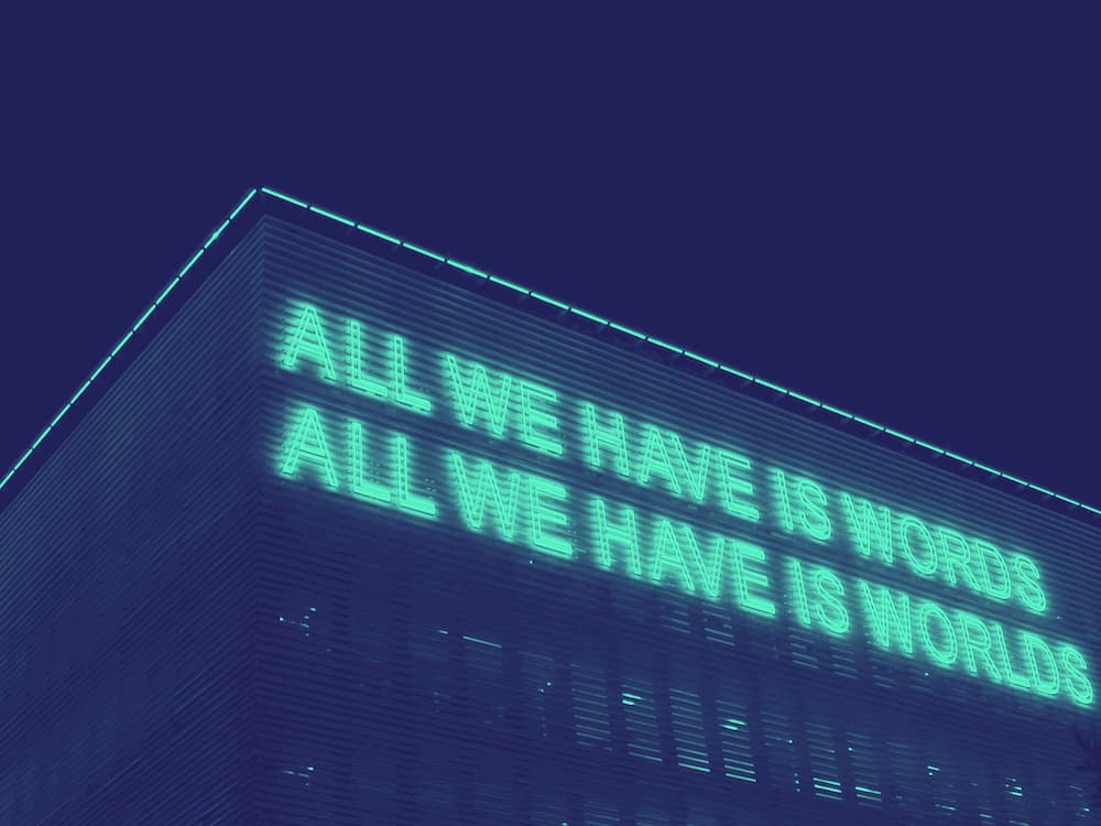From-Scratch-Communications_Make-your-company-LGBT-friendly-2 Neon sign reading: "All we have is words / all we have is worlds"