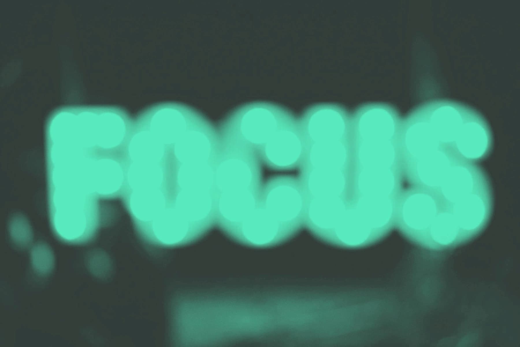 from-scratch-communications-web-audit-for the-rainforest_which-call-to-action-is-best A blurry image of the word 'focus' in green in front of a dark grey backdrop