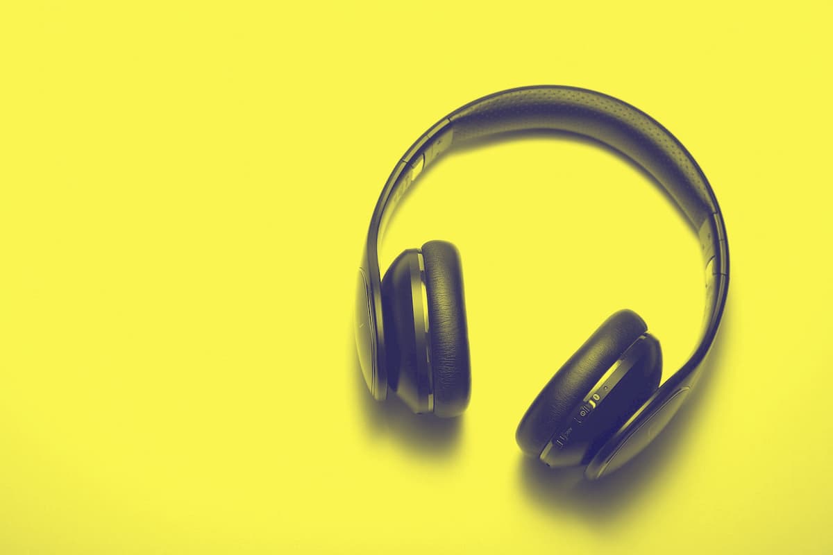 from-scratch-communications_writing-with-self-empathy dark blue, padded headphones on yellow background