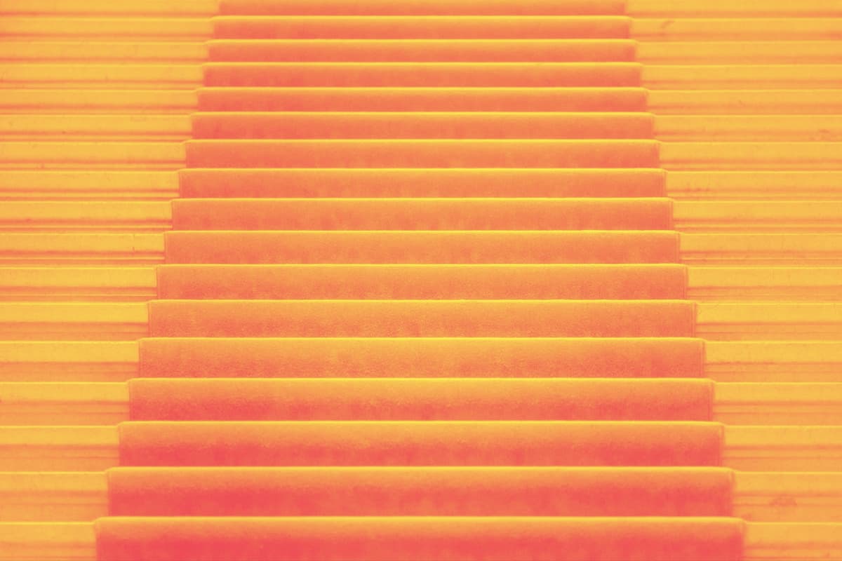 live-more-offline-web-audit-is-my-sales-page-too-long_compr_from-scratch-communications stairs with a red carpet. the top of the stairs is invisible