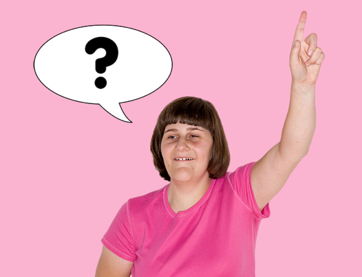 A woman raises her hand to ask a question.