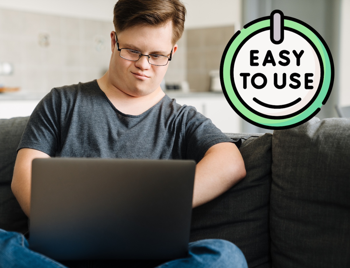 A man with Down syndrome works on his laptop. A badge next to him says "easy to use".