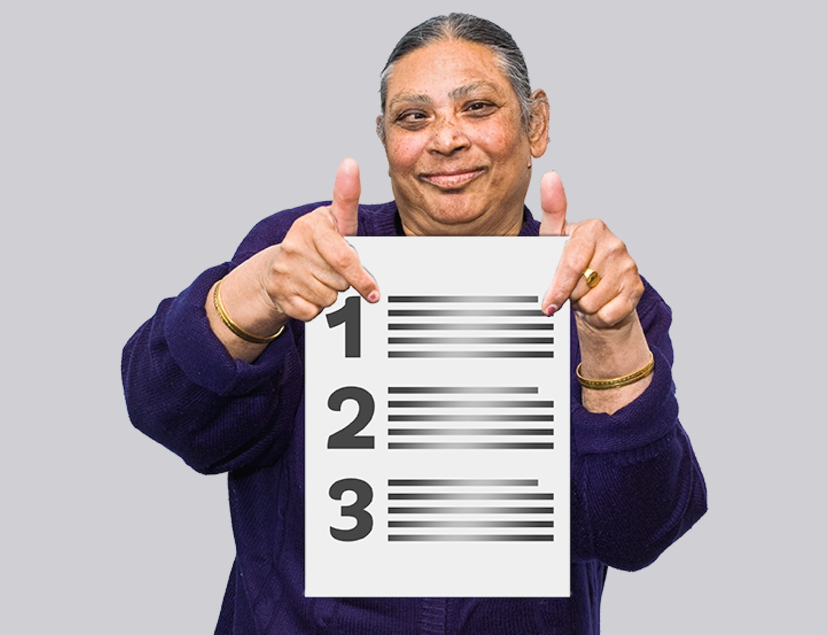 A Brown woman is holding a list and pointing at number 1.